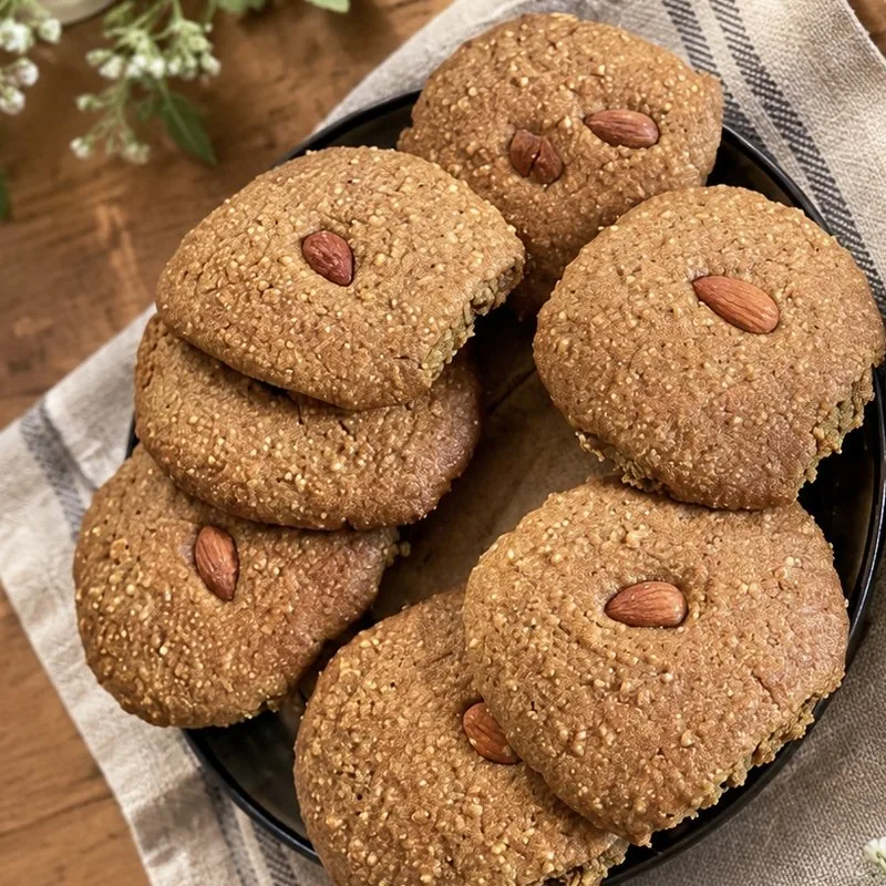 Oat and green buckwheat cookies, each topped with an almond
